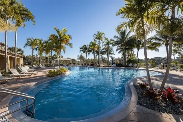 a view of swimming pool with outdoor seating and plants
