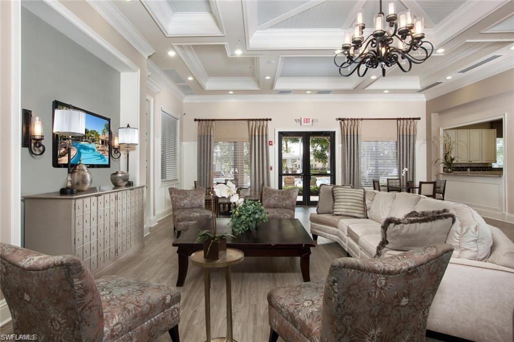 6529 Marbella Drive Naples, FL 34105 - Photo 25 of 29 a living room with furniture flowers and a chandelier