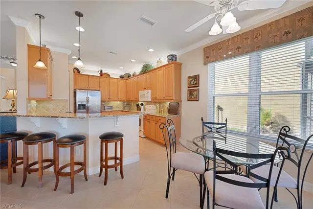 a large kitchen with lots of counter top space and dining table