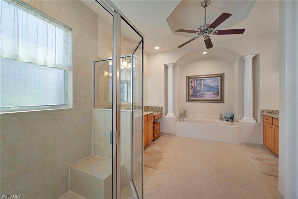 6529 Marbella Drive Naples, FL 34105 - Photo 9 of 29 a spacious bathroom with a bathtub and a shower