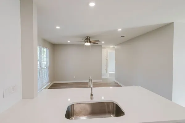 a kitchen with a sink and chandelier