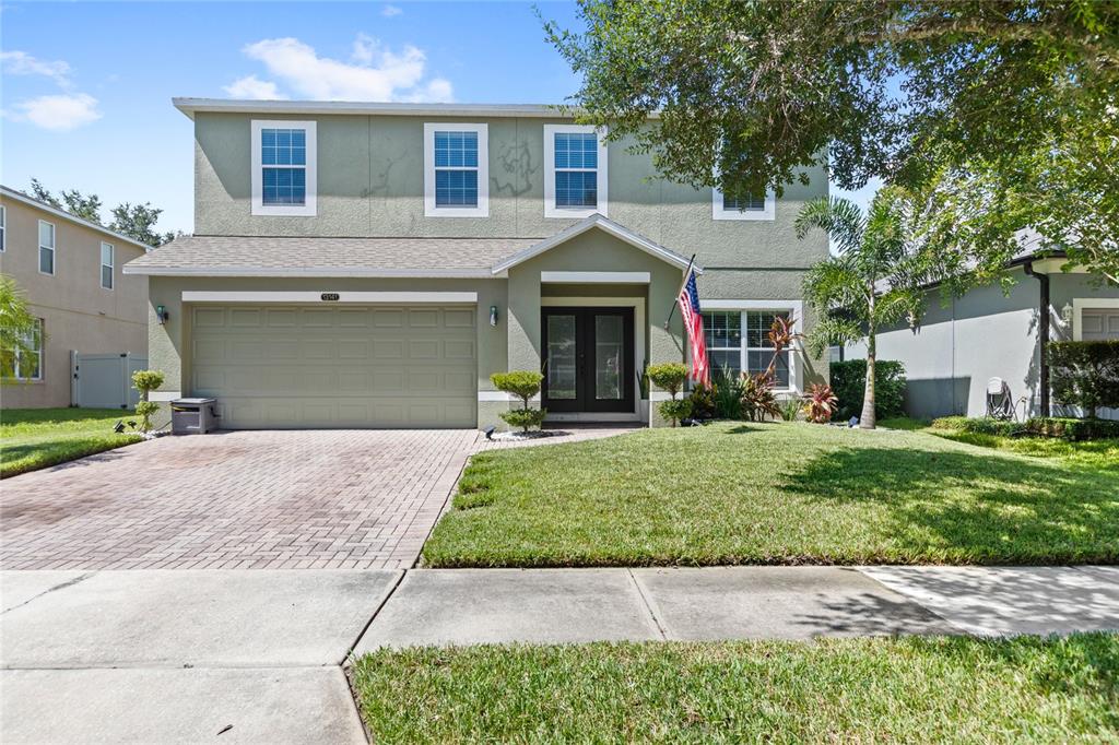 13141 Moss Park Ridge Drive Orlando, FL 32832 - Photo 1 of 1 a front view of a house with a yard and garage