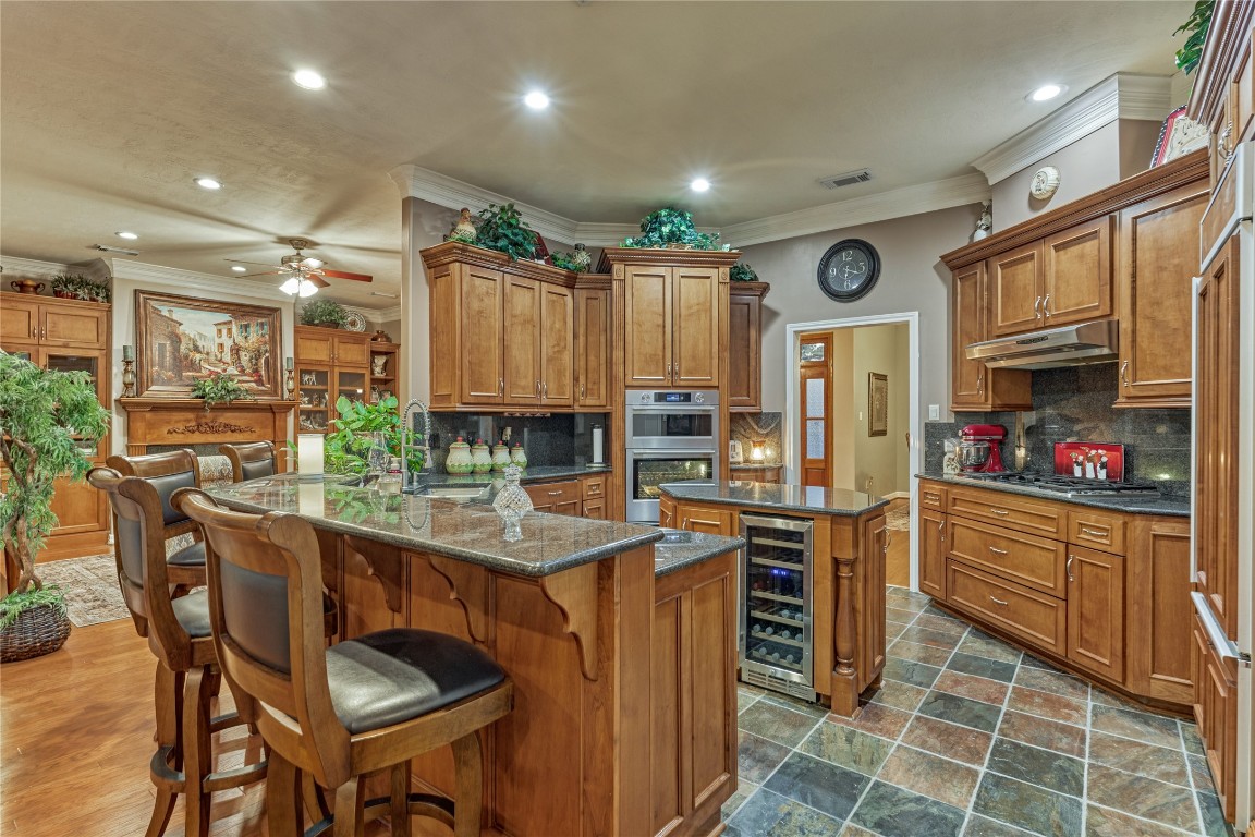 27 Bent Tree Lane Montgomery, TX 77356 - Photo 23 of 50 A striking gourmet kitchen showcases rich wood cabinetry granite counters, stainless steel appliances, 5-burner gas stovetop and a built-in fridge/freezer.