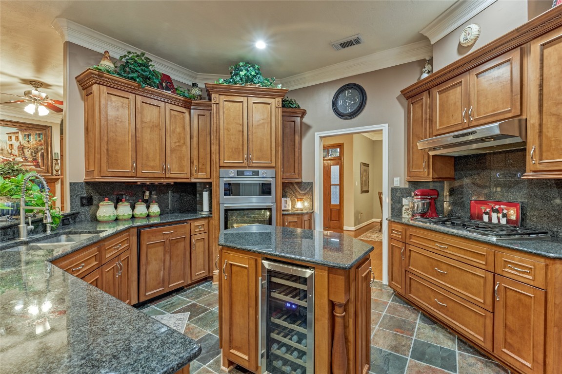 27 Bent Tree Lane Montgomery, TX 77356 - Photo 24 of 50 Host with ease - the center island provides prep space, storage, and features a beverage fridge for quick-access to perfectly chilled beverages.