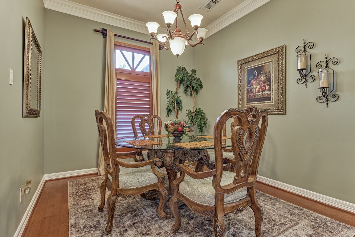 27 Bent Tree Lane Montgomery, TX 77356 - Photo 10 of 50 The formal dining room exudes elegance with rich wood flooring and sophisticated crown molding, creating the perfect setting for intimate dinners or festive gatherings.