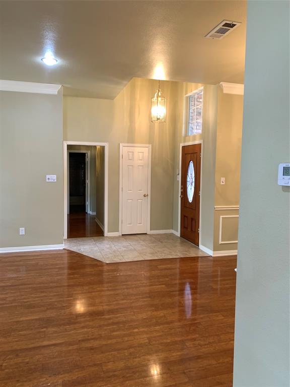 4914 Shadowood Road Colleyville, TX 76034 - Photo 16 of 28 Foyer entrance featuring wood finished floors and ornamental molding