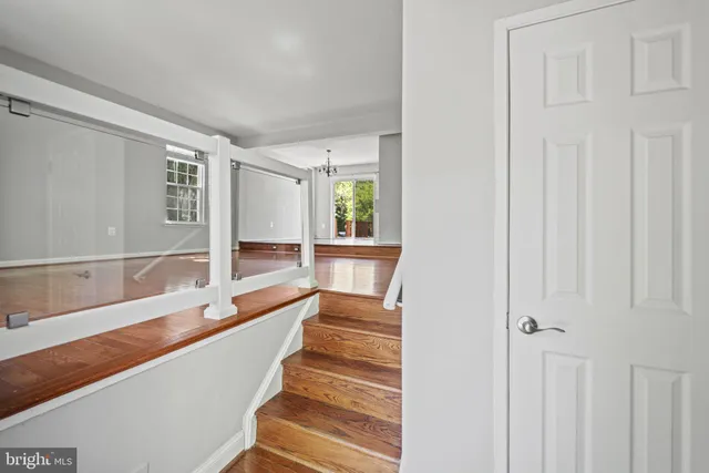 a view of entryway and hall with wooden floor