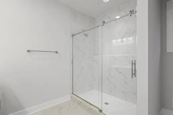 a bathroom with a glass shower door