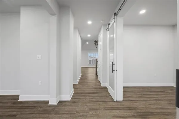 a view of a hallway with wooden floor and staircase