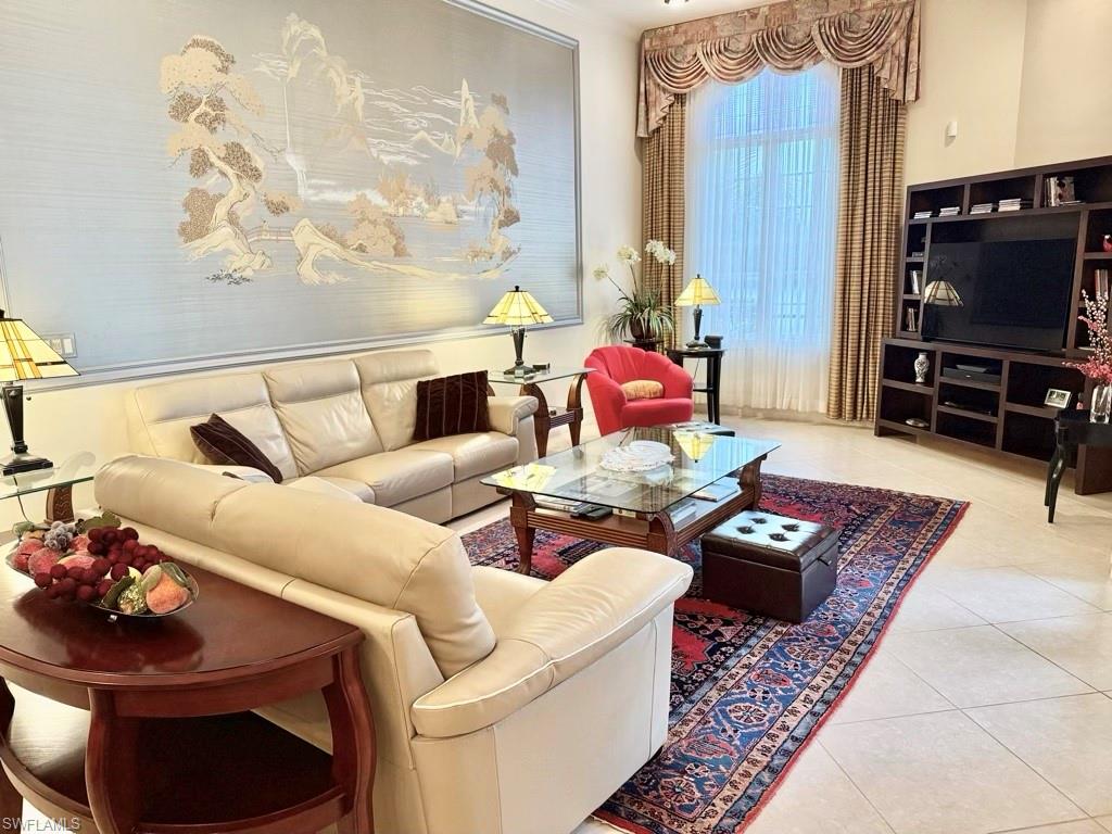 8064 Tiger Lily Drive Naples, FL 34113 - Photo 13 of 21 a living room with furniture and a flat screen tv