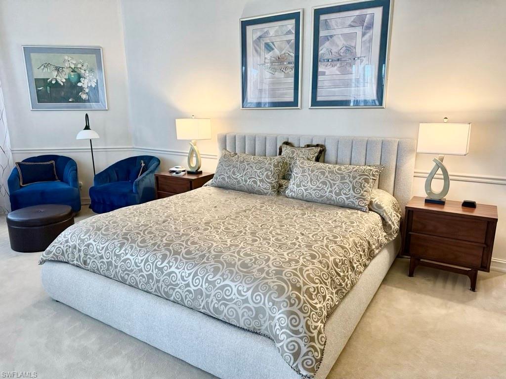 8064 Tiger Lily Drive Naples, FL 34113 - Photo 16 of 21 a bedroom with bed and a lamp on table