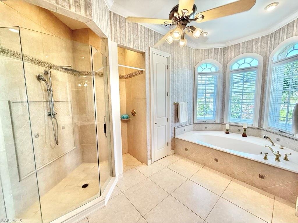 8064 Tiger Lily Drive Naples, FL 34113 - Photo 17 of 21 a spacious bathroom with a shower a sink and a large mirror
