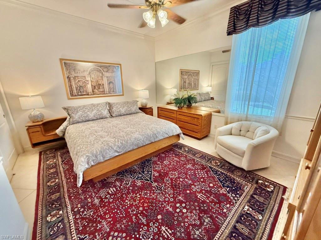 8064 Tiger Lily Drive Naples, FL 34113 - Photo 19 of 21 a bedroom with large bed and a couch