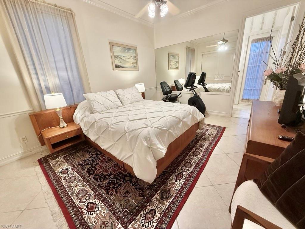 8064 Tiger Lily Drive Naples, FL 34113 - Photo 20 of 21 a bed room with a bed and a couch