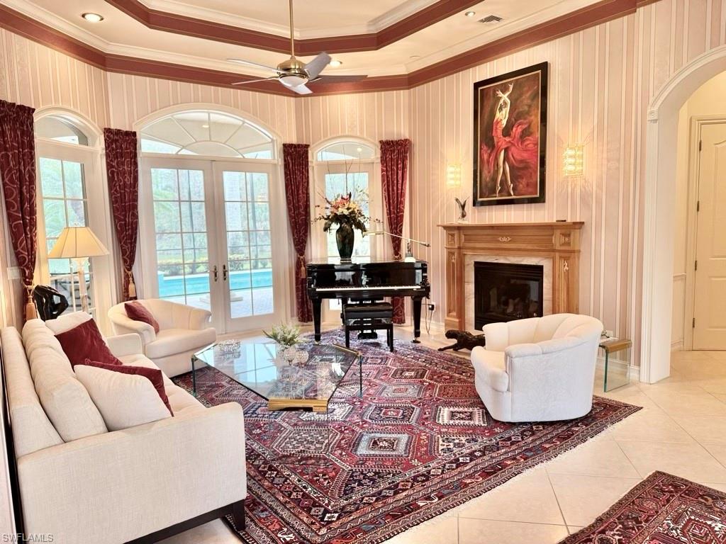 8064 Tiger Lily Drive Naples, FL 34113 - Photo 9 of 21 a living room with furniture or couch and a fireplace