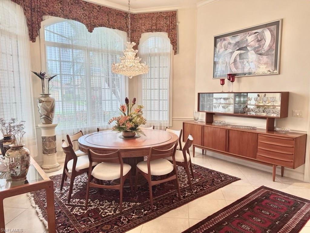8064 Tiger Lily Drive Naples, FL 34113 - Photo 10 of 21 a view of a dining room with furniture and wooden floor