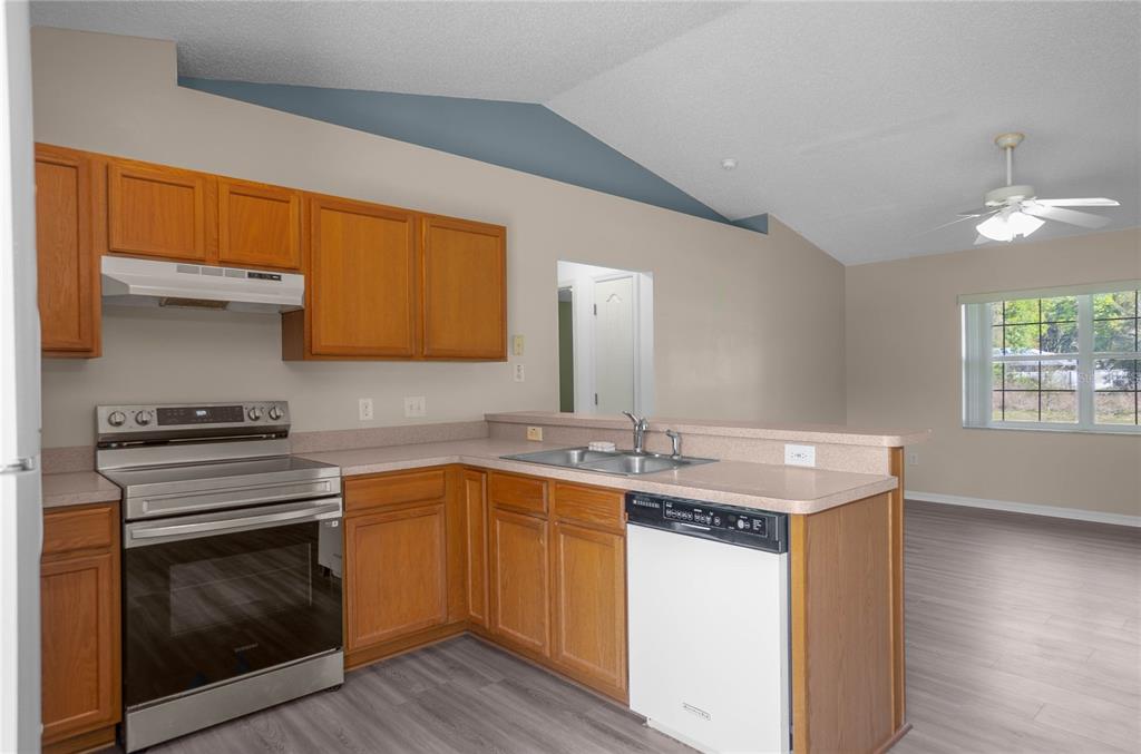 3926 East Bennett Street Inverness, FL 34453 - Photo 14 of 33 a kitchen with a sink stove and cabinets