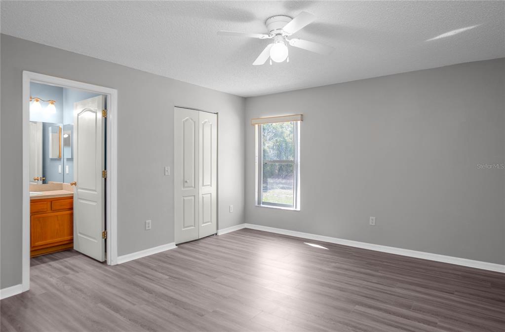 3926 East Bennett Street Inverness, FL 34453 - Photo 15 of 33 an empty room with wooden floor and a window