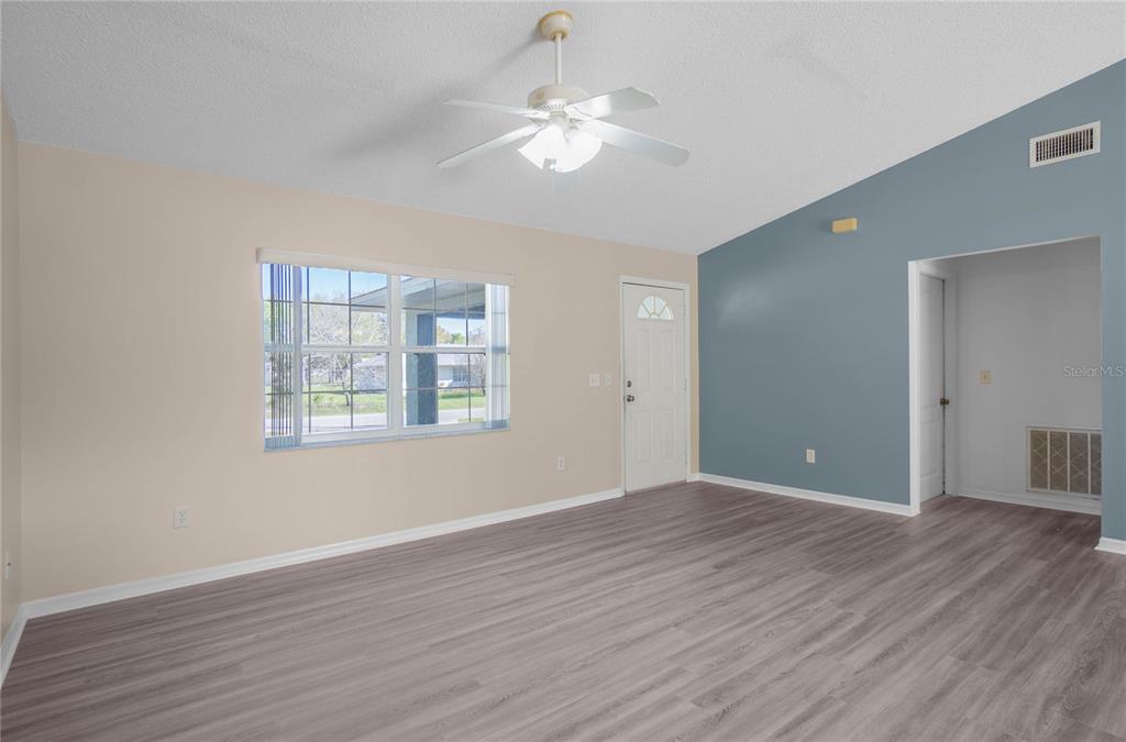 3926 East Bennett Street Inverness, FL 34453 - Photo 8 of 33 a view of an empty room with wooden floor and a window