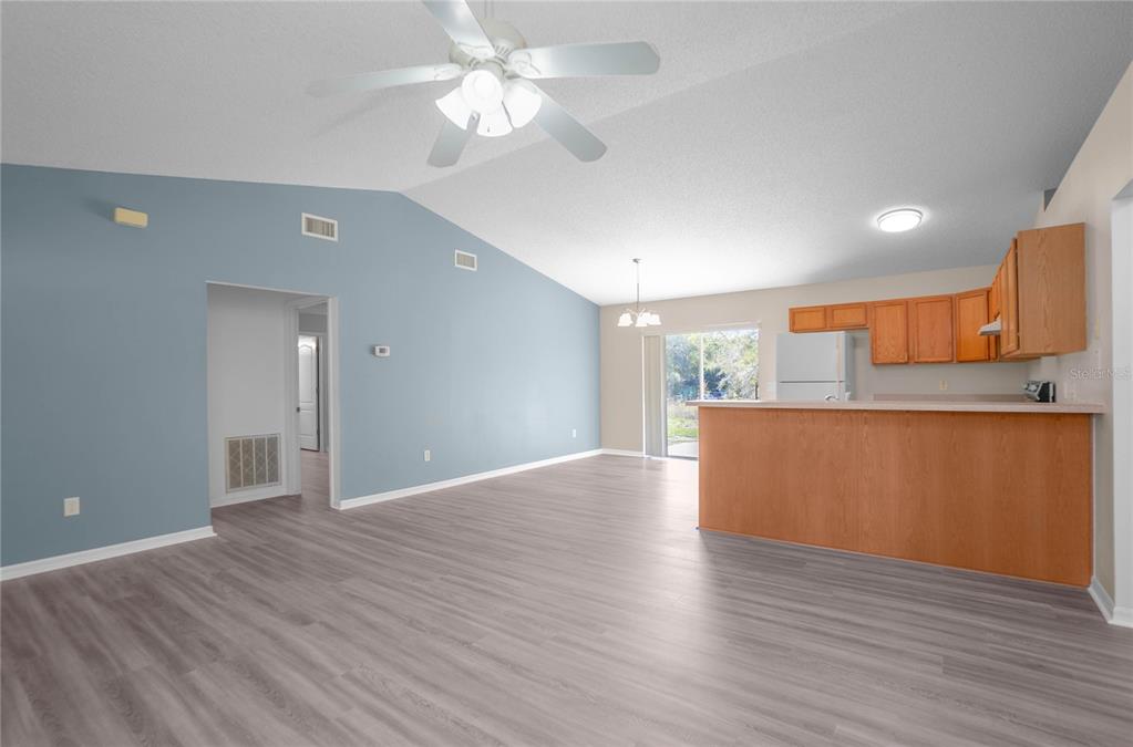 3926 East Bennett Street Inverness, FL 34453 - Photo 9 of 33 a view of kitchen and empty room with wooden floor