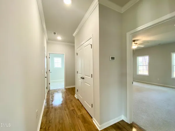 a view of a room with a ceiling fan and a window