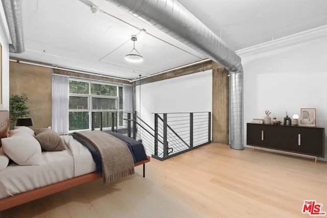 a bedroom with a bed and a large window