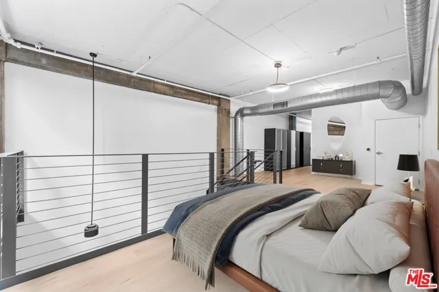 a bedroom with a bed and ceiling fan