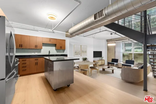 a kitchen with stainless steel appliances granite countertop a stove and a refrigerator