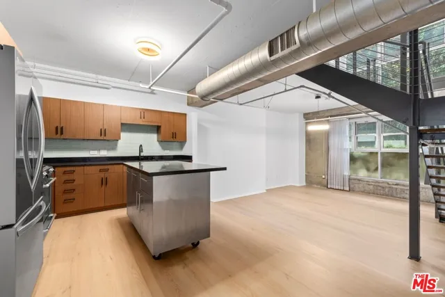 a kitchen with stainless steel appliances granite countertop a sink and a stove