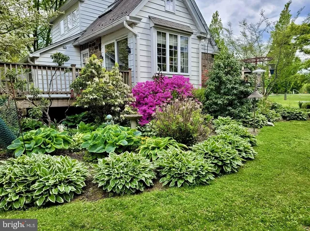 a view of a house with a flower garden