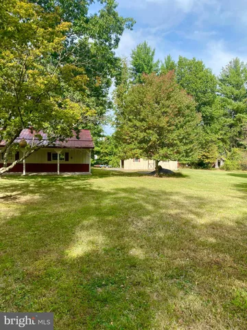 a swimming pool with lawn chairs and trees