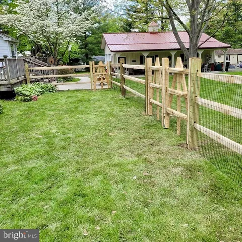 a view of a house with a yard porch and sitting area
