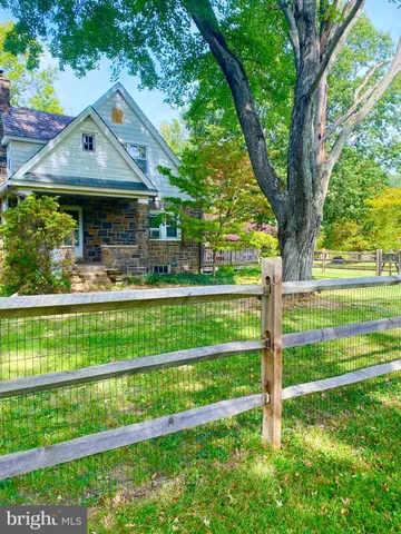 a front view of a house with a yard table and chairs