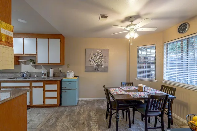 a view of a dining room with furniture and chandelier