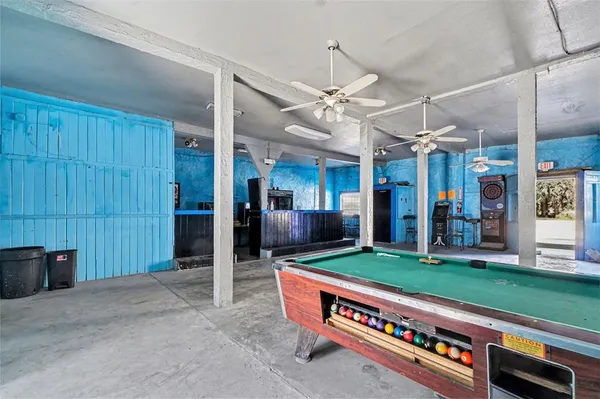 a large kitchen with lots of shelves and stainless steel appliances