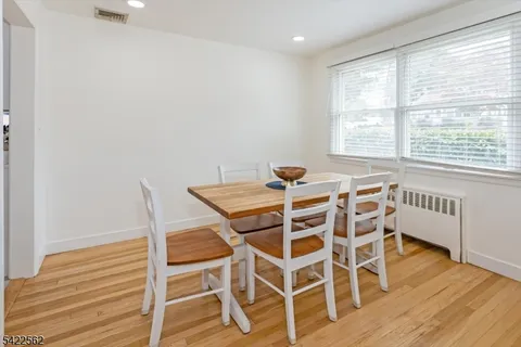 a kitchen with white cabinets and refrigerator
