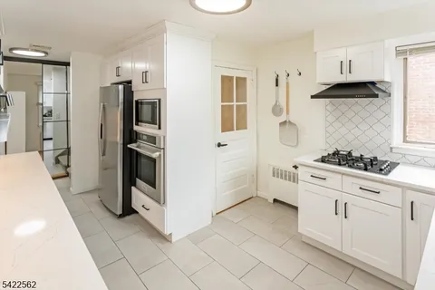 a kitchen with cabinets stainless steel appliances and counter space