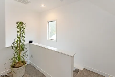a large bed sitting in a room next to a window