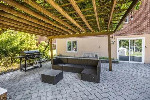 a living room with furniture and a grill