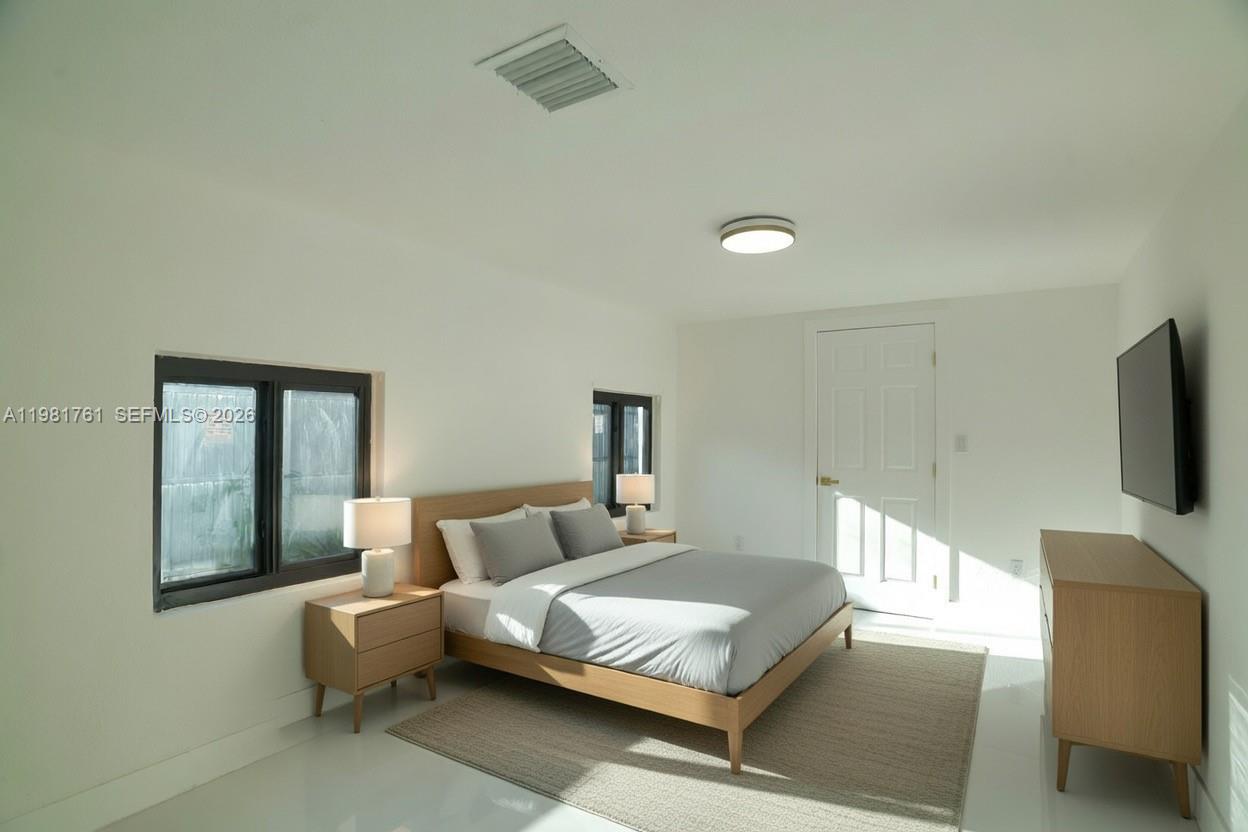 315 Northwest 127th Street North Miami, FL 33168 - Photo 13 of 67 a bedroom with a bed and a flat screen tv