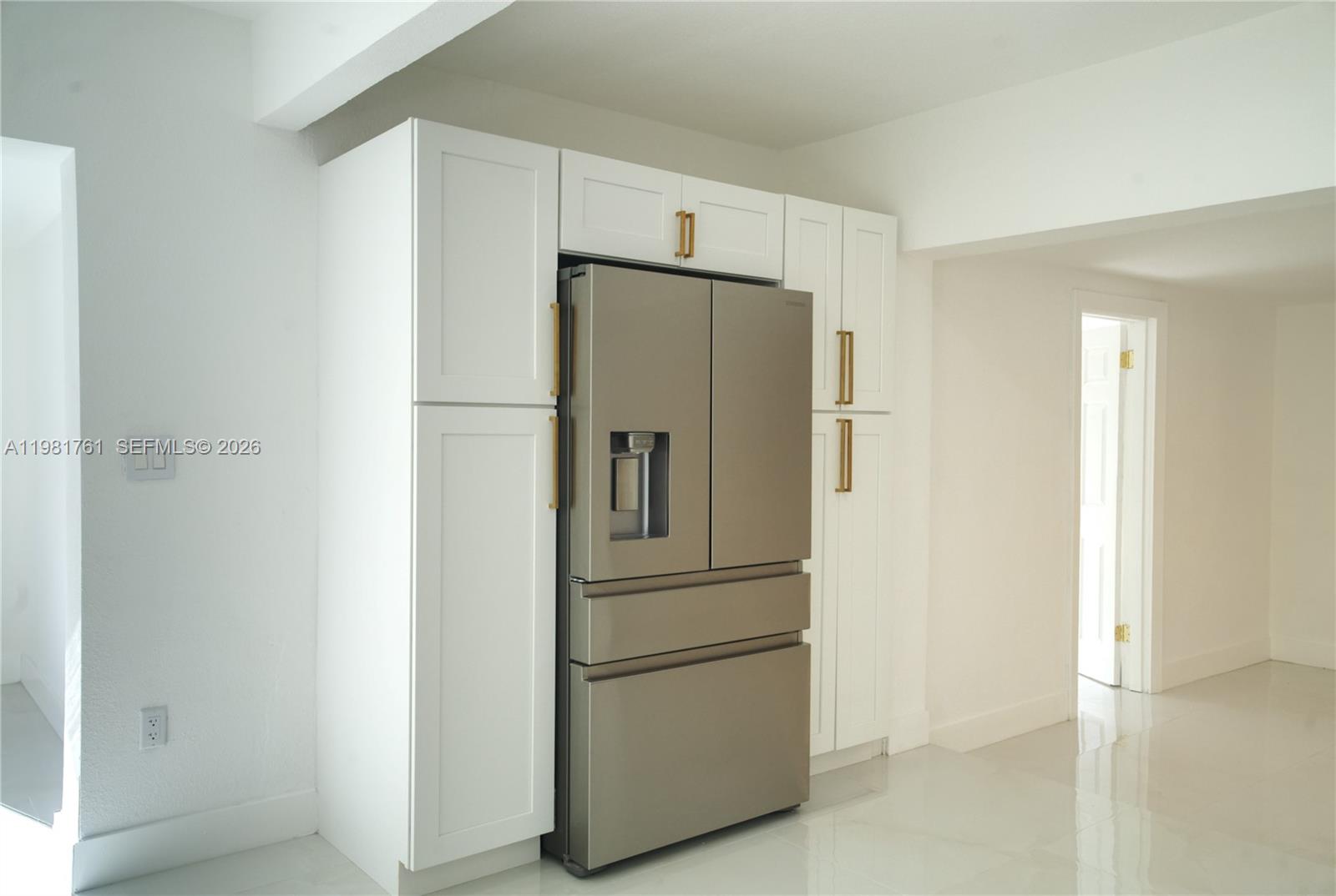 315 Northwest 127th Street North Miami, FL 33168 - Photo 19 of 67 a metallic refrigerator freezer sitting in a kitchen