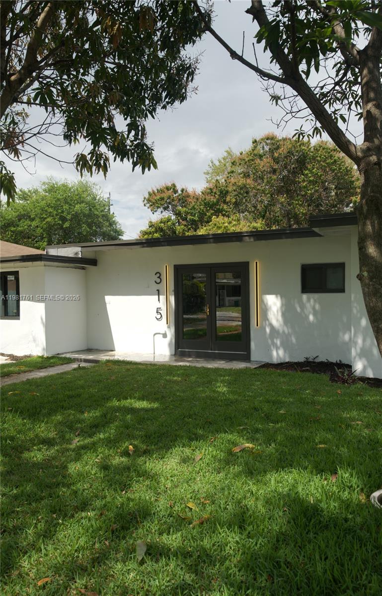 315 Northwest 127th Street North Miami, FL 33168 - Photo 2 of 67 a front view of a house with a garden and yard