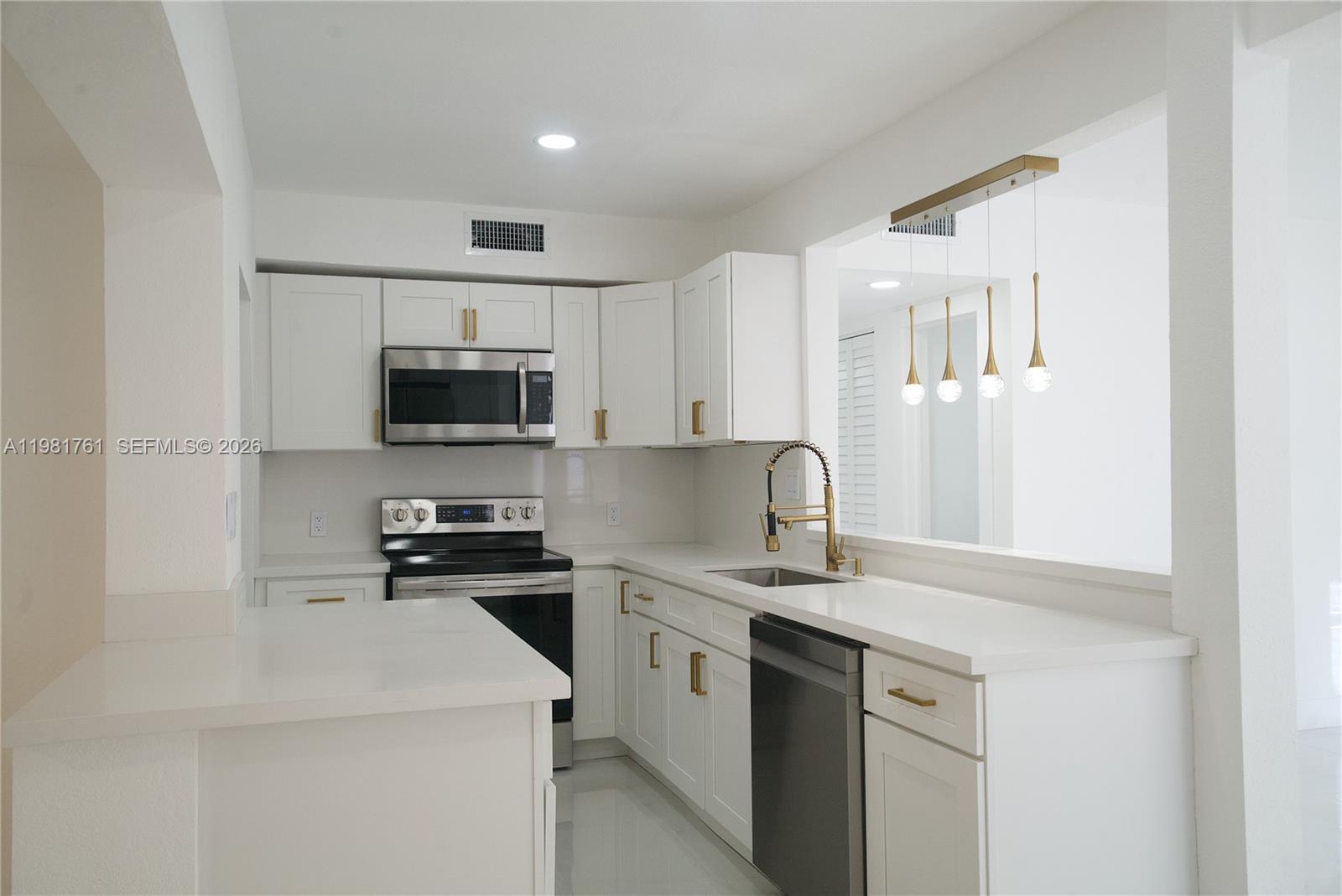 315 Northwest 127th Street North Miami, FL 33168 - Photo 22 of 67 a kitchen with a sink stove and microwave