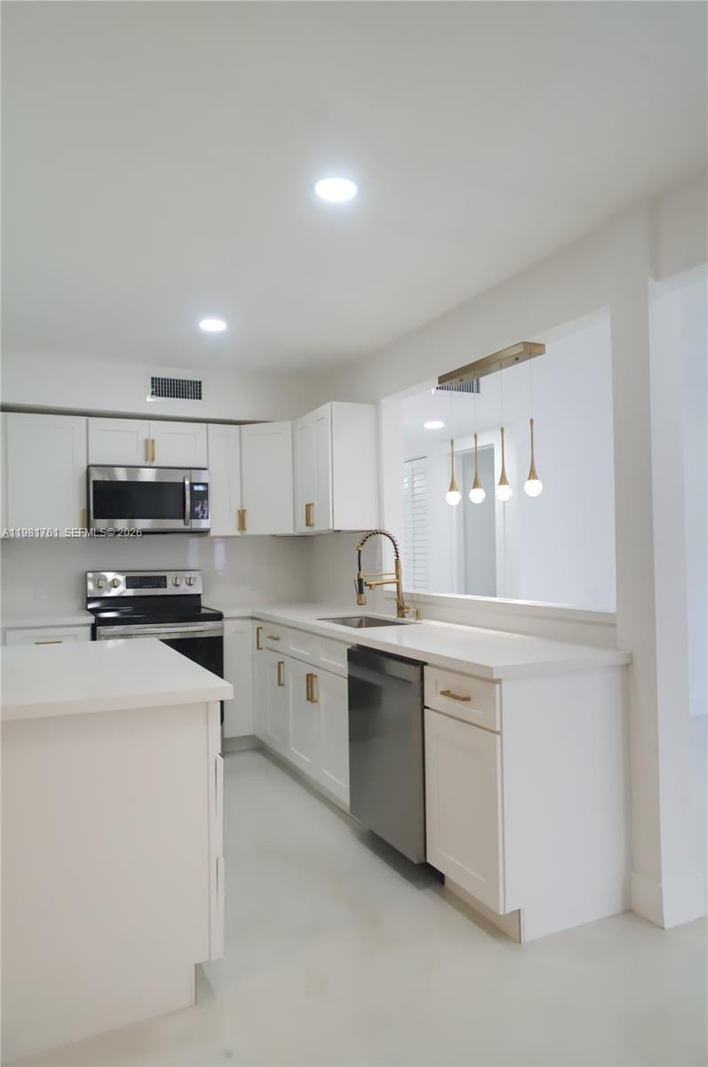 315 Northwest 127th Street North Miami, FL 33168 - Photo 23 of 67 a kitchen with stainless steel appliances a stove sink and microwave
