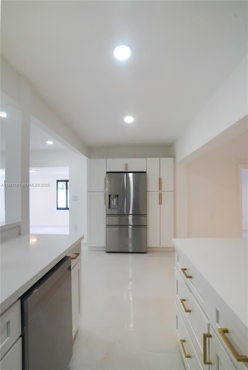 315 Northwest 127th Street North Miami, FL 33168 - Photo 24 of 67 a kitchen with granite countertop white cabinets and stainless steel appliances