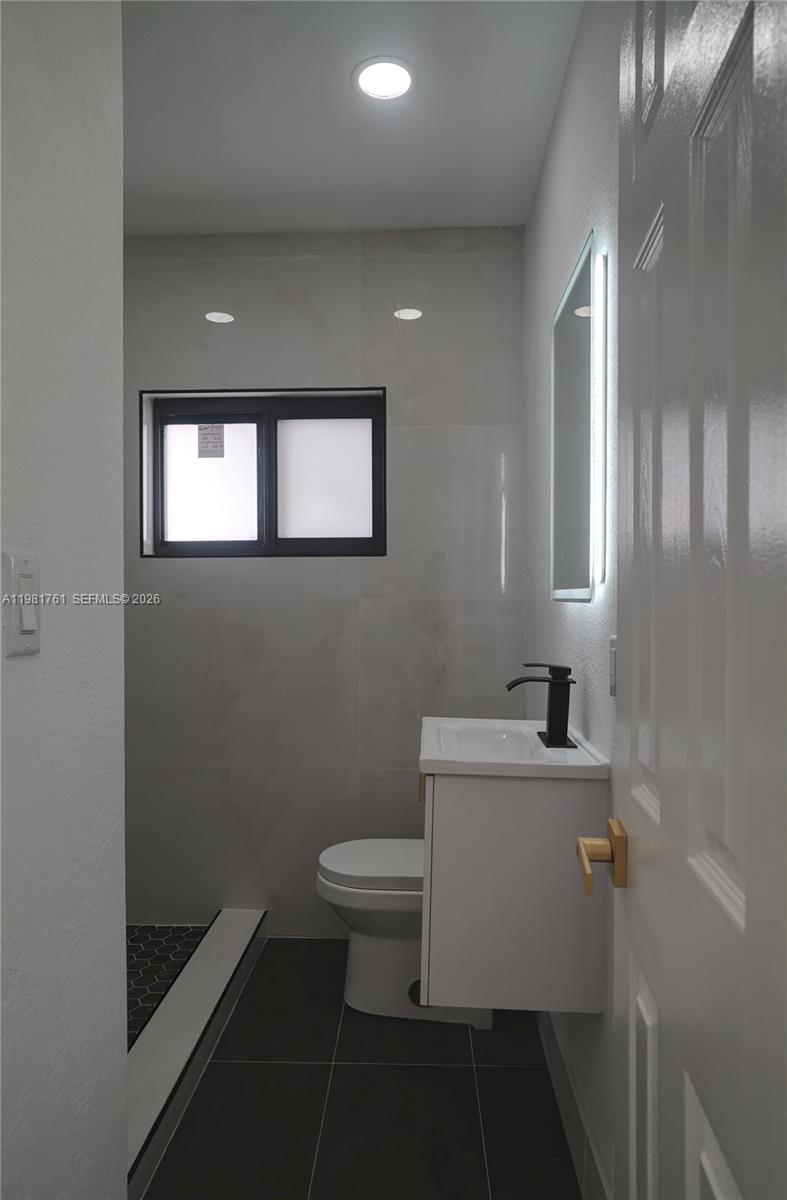315 Northwest 127th Street North Miami, FL 33168 - Photo 28 of 67 a bathroom with a toilet a sink and mirror