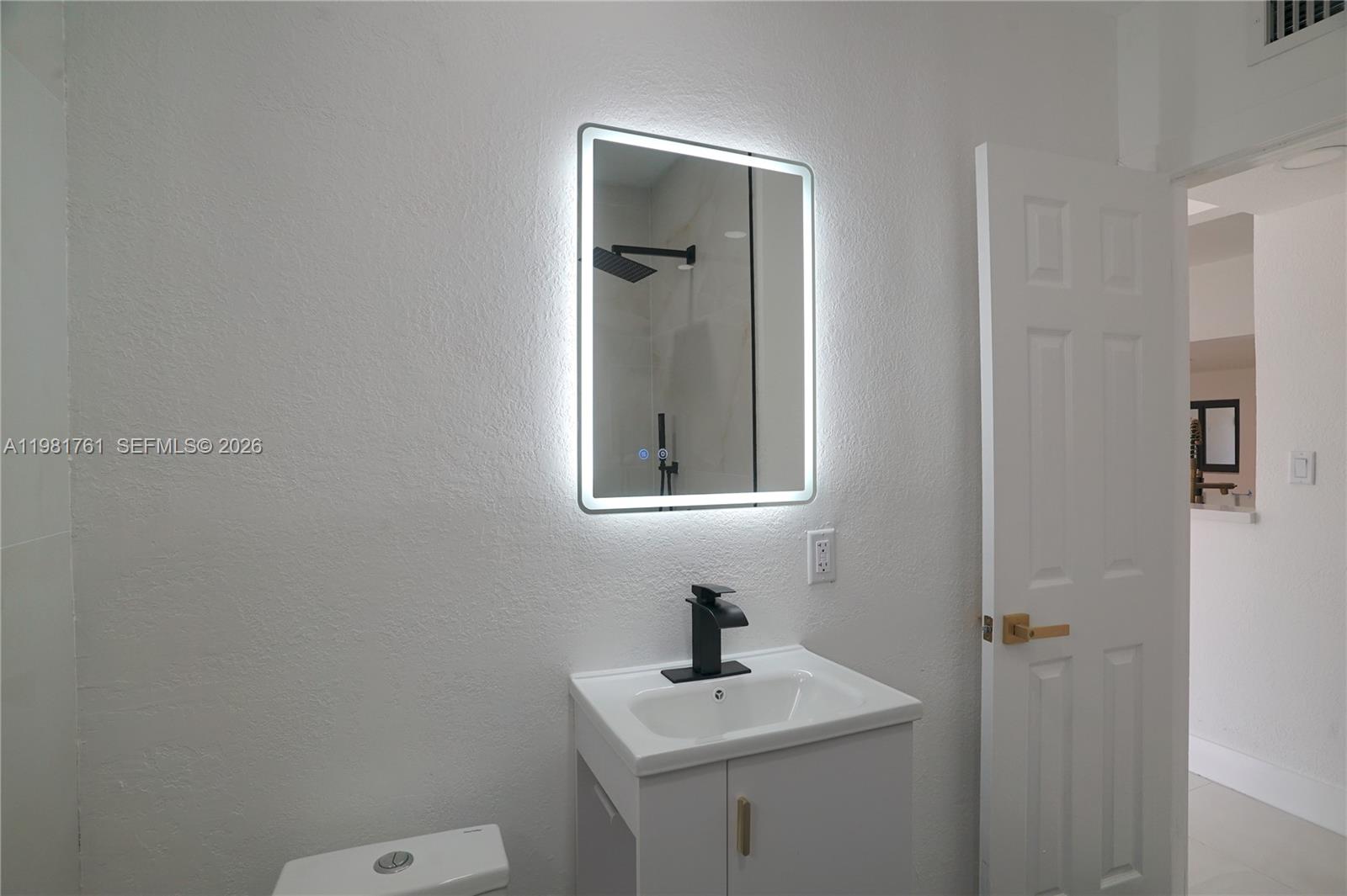 315 Northwest 127th Street North Miami, FL 33168 - Photo 29 of 67 a bathroom with a sink mirror and toilet