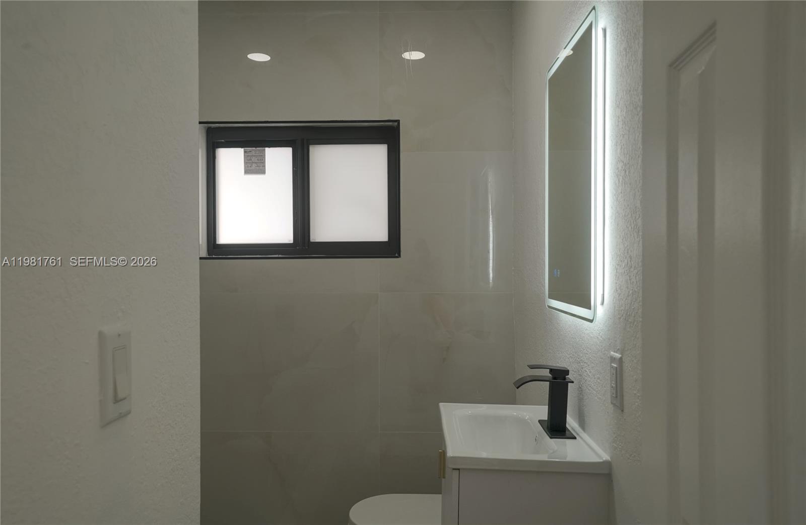 315 Northwest 127th Street North Miami, FL 33168 - Photo 33 of 67 a bathroom with a toilet a sink a mirror and vanity