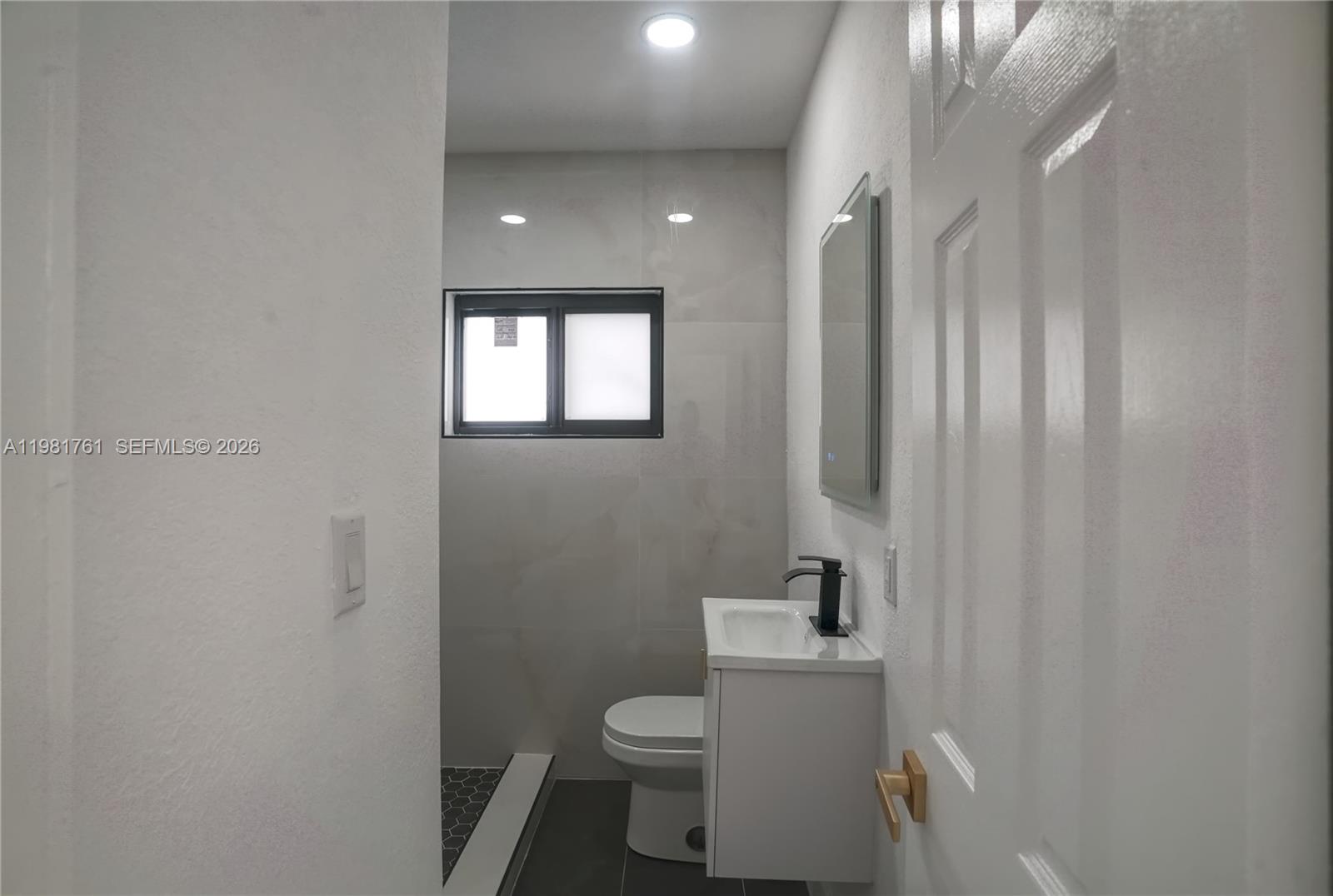 315 Northwest 127th Street North Miami, FL 33168 - Photo 34 of 67 a white toilet sitting next to a bathroom sink