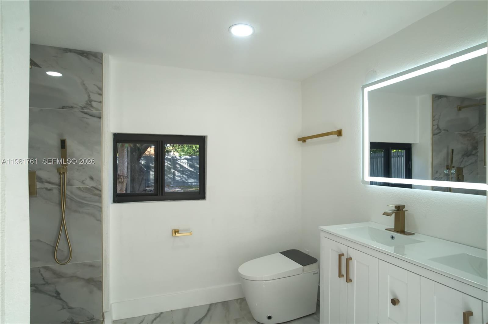 315 Northwest 127th Street North Miami, FL 33168 - Photo 45 of 67 a bathroom with a toilet sink and mirror